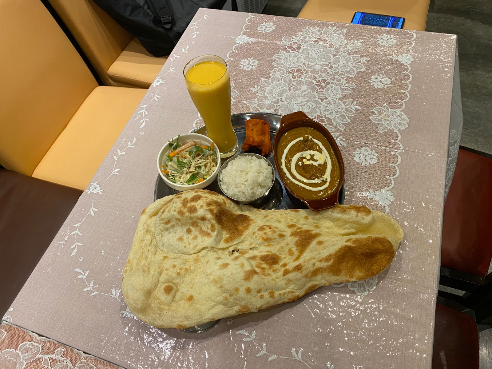 Set meal with naan, curry, rice, tikka, salad, and drink